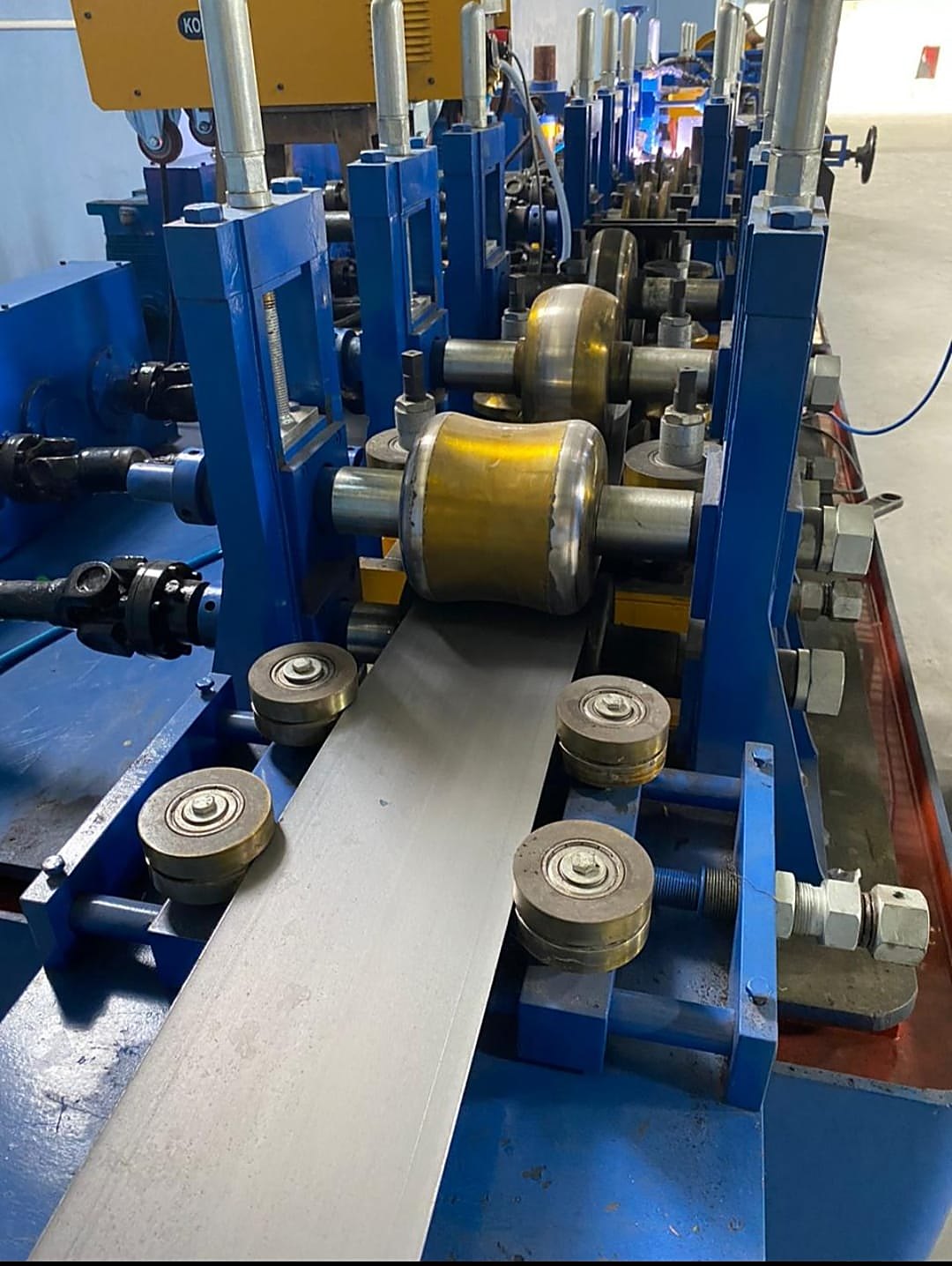Strip entering the forming rolls of the ERW tube mill